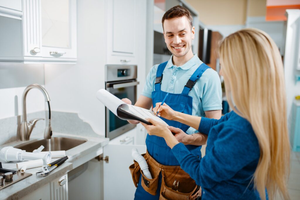male-plumber-and-female-customer-in-the-kitchen.jpg
